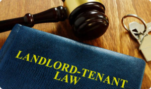 Book with Landlord-tenant law keys and hammmer