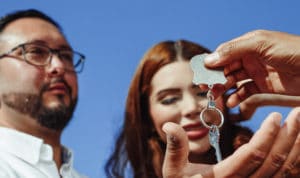 couple getting handed the keys to a house or inherited property
