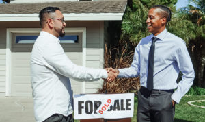 landlord and investor shake hands when to sell your rental property