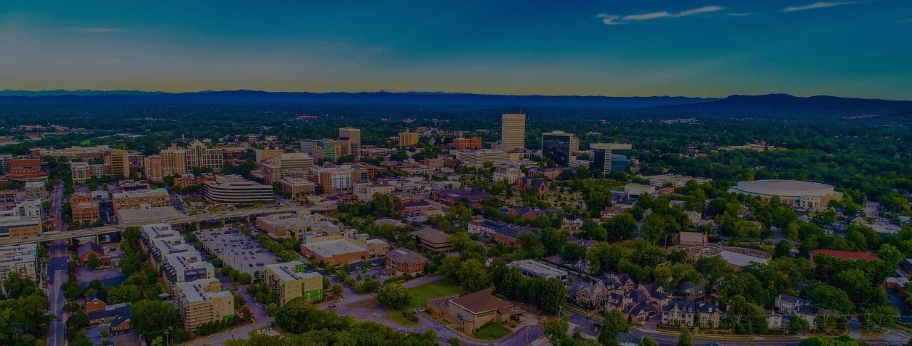 we buy houses aerial view of downtown greenville, south carolina skyline